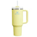 Yellow tumbler with handle and straw lid on a white background