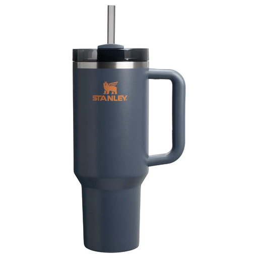Navy blue Stanley mug with handle and straw on a white background
