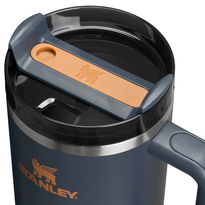 Blue Stanley travel mug with a brown handle on a white background