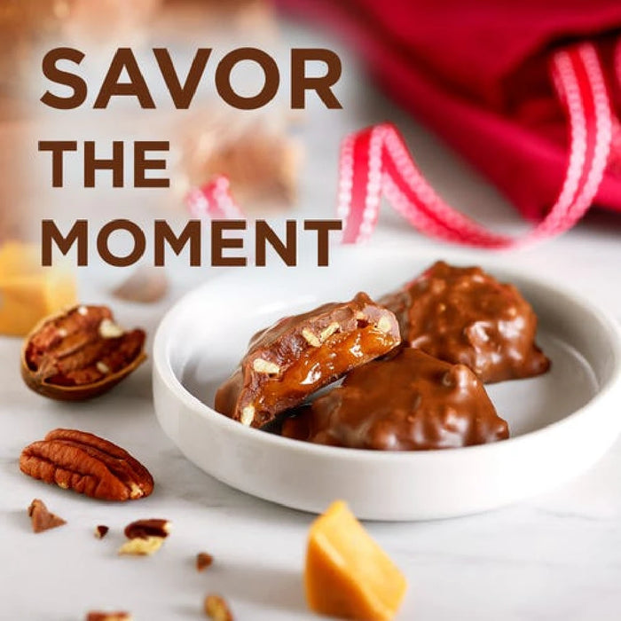 Close-up of a Russell Stover coconut nest, enveloped in smooth milk chocolate, highlighting its coconut filling and nest shape.