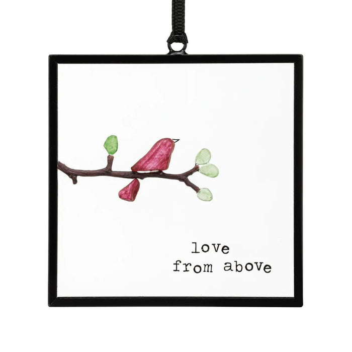 Framed artwork of a bird on a branch with 'love from above' text.