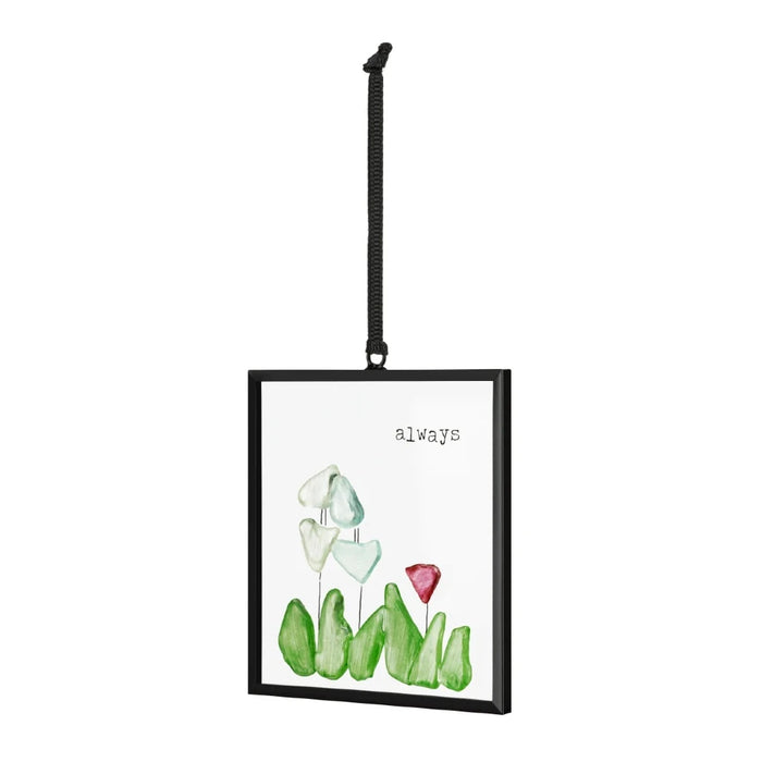 A small card adorned with a picture of blooming flowers and a sun catcher.