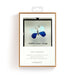A blue butterfly spreads its wings, perched on a leaf, highlighting its intricate patterns and vivid blue hues.