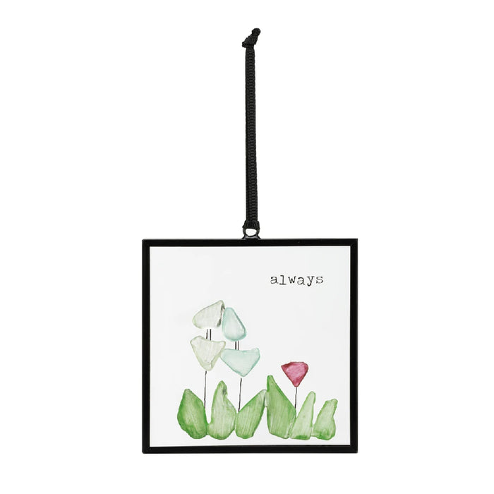 A small card featuring a colorful illustration of flowers alongside a decorative sun catcher.