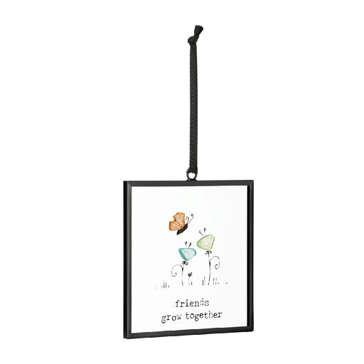 Colorful butterfly ornament with the phrase "friends are like butterflies" displayed on a decorative background.