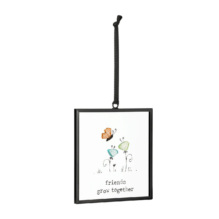 Colorful butterfly ornament with the phrase "friends are like butterflies" displayed on a decorative background.