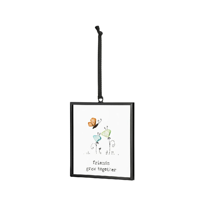 Decorative ornament featuring butterflies and the quote "friends are like butterflies" in a vibrant design.