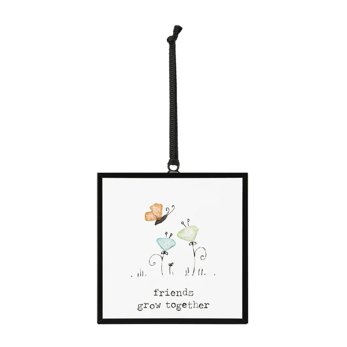 Framed wall art featuring a butterfly and a bird, showcasing vibrant colors and intricate details in a natural setting.
