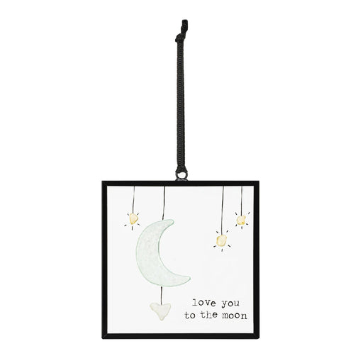 A decorative hanging ornament with the phrase "I love you to the moon and back" in elegant lettering.