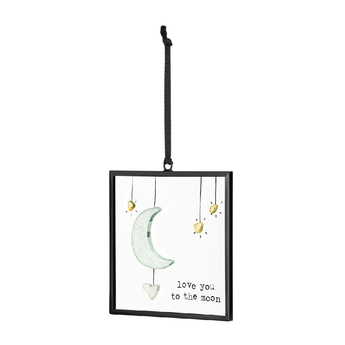 An ornament that reads "I love you to the moon and back," designed to convey a message of enduring love.