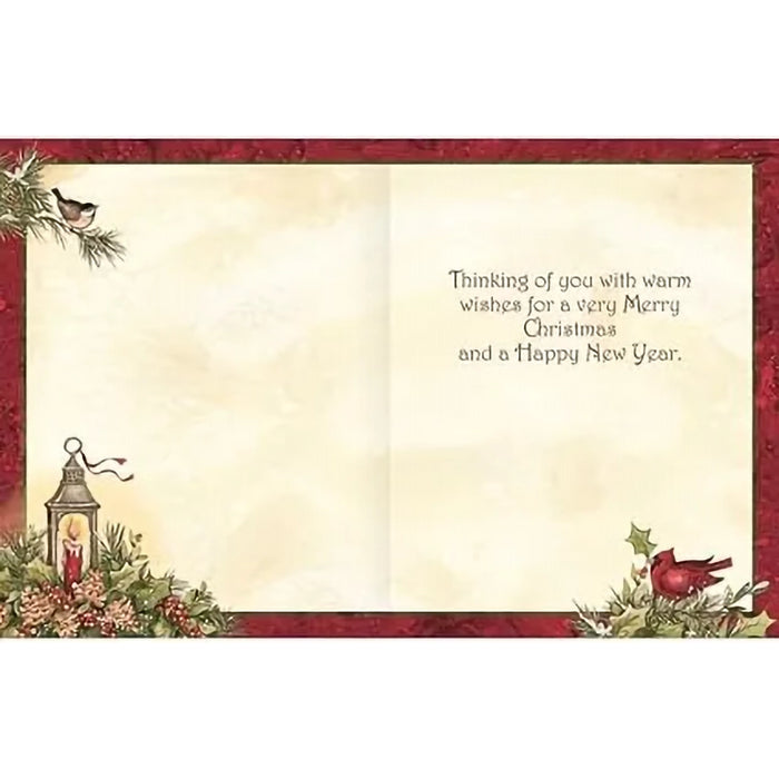 Christmas card with decorative border, lantern, and cardinal bird on a white background.