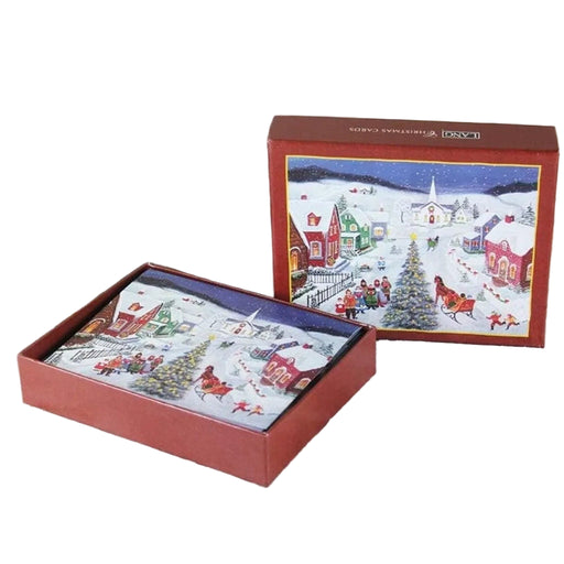 Christmas-themed gift box with festive design on a wooden surface with pine cones and greenery.