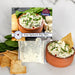 A container of feta spinach dip mix, showcasing a blend of feta cheese and spinach, perfect for party snacks.