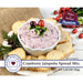 A jar of cranberry jalapeño spread mix, showcasing a vibrant red color with visible jalapeño pieces and spices.