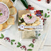 A container of cranberry jalapeño spread mix, highlighting its bright red color and bits of jalapeño throughout.