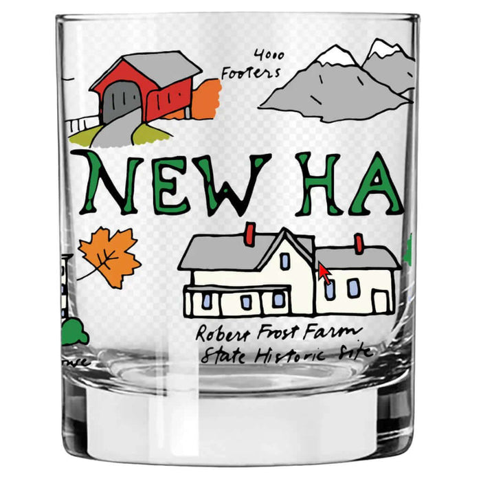 Glass with illustrations of a barn, mountains, and houses with text on a white background
