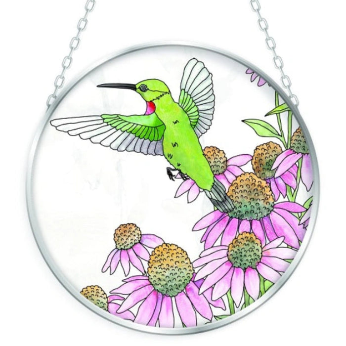 This Bridgeton Hall Hummingbird and Coneflowers Suncatcher captures the beauty of a hummingbird visiting vibrant coneflowers in a colorful nature-inspired design.