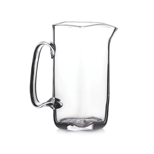 Clear glass pitcher with a handle, set against a plain white background.