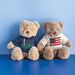 A teddy bear wearing a cozy sweater adorned with the American flag, symbolizing patriotism and warmth.