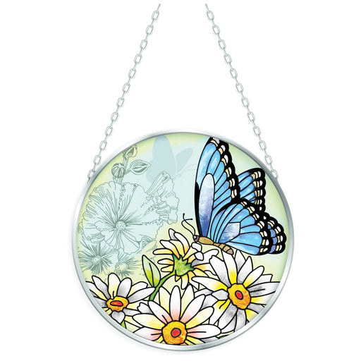 Blue Morpho butterfly stained-glass-style suncatcher with vibrant blue wings hanging in a sunny window.