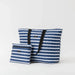 A stylish blue and white striped tote bag with a matching pouch, perfect for carrying essentials.