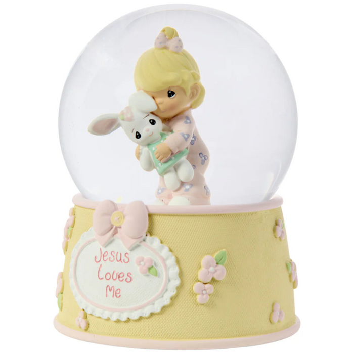 This snow globe, a young girl snuggles her sweet bunny.