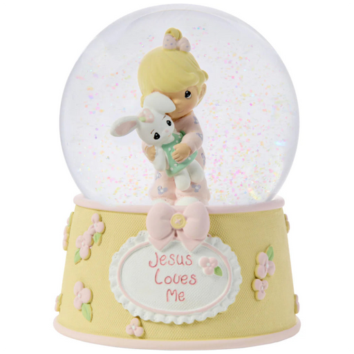 This snow globe, a young girl snuggles her sweet bunny.