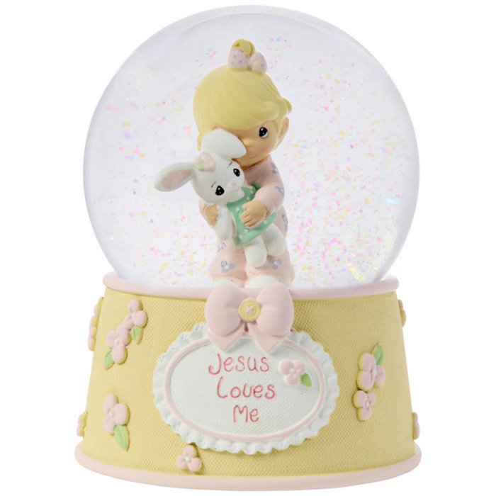 This snow globe, a young girl snuggles her sweet bunny.