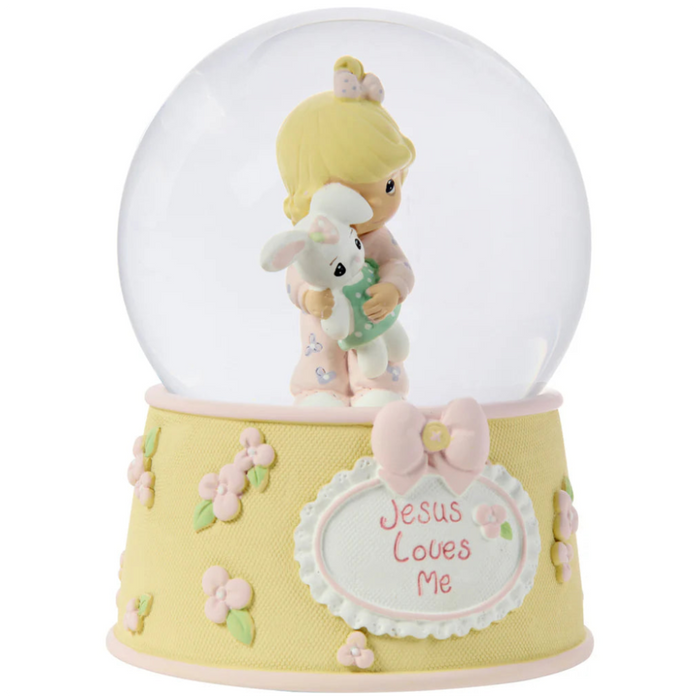 This snow globe, a young girl snuggles her sweet bunny.
