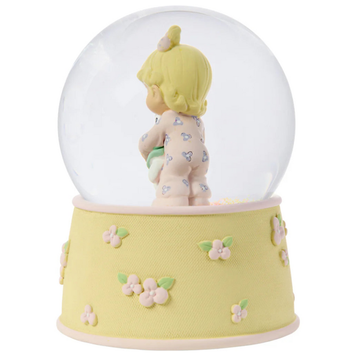 This snow globe, a young girl snuggles her sweet bunny.