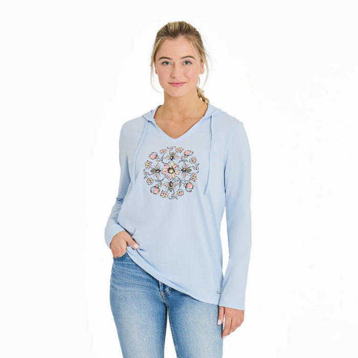 Woman wearing a light blue hoodie with a floral design on a white background