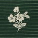 White floral embroidery on a green striped fabric background