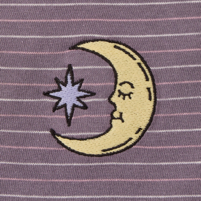 Embroidered design of a half-moon with a star on a striped purple background