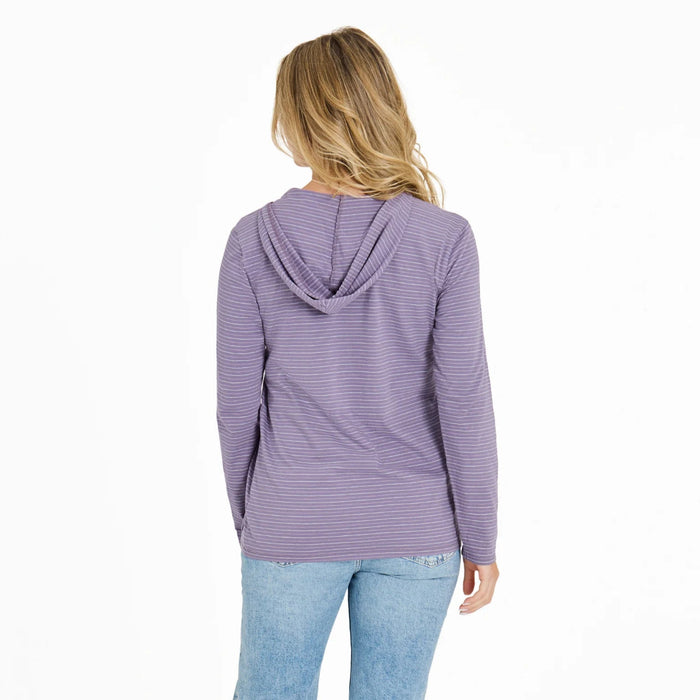 Woman wearing a purple striped hoodie and light blue jeans on a white background