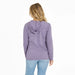 Woman wearing a purple striped hoodie and light blue jeans on a white background