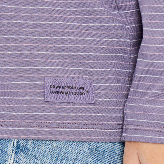 Purple striped shirt with "Do what you love. Love what you do." label on a person wearing jeans