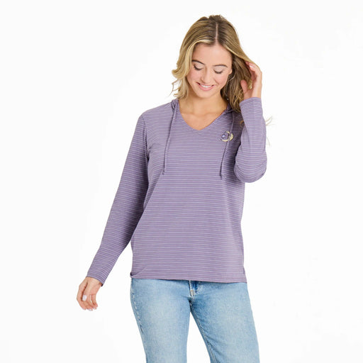 Woman wearing a purple striped long-sleeve top and blue jeans on a white background