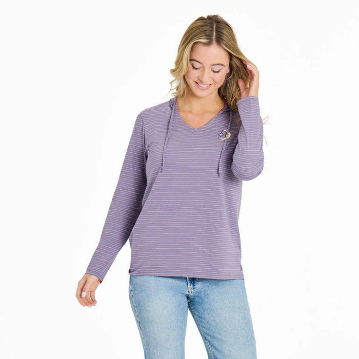 Woman wearing a purple striped long-sleeve top and blue jeans on a white background