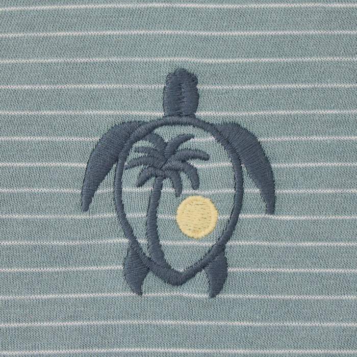 Embroidered turtle design with palm tree and sun on a striped fabric background