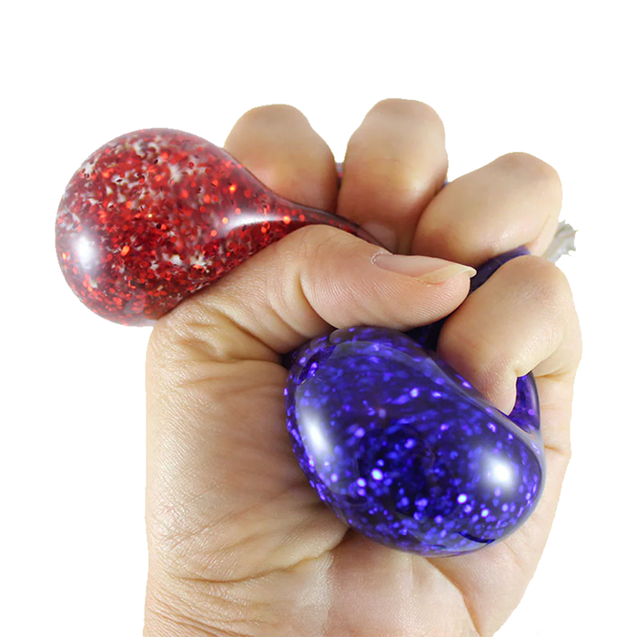 Hand holding a red and purple stress ball against a white background