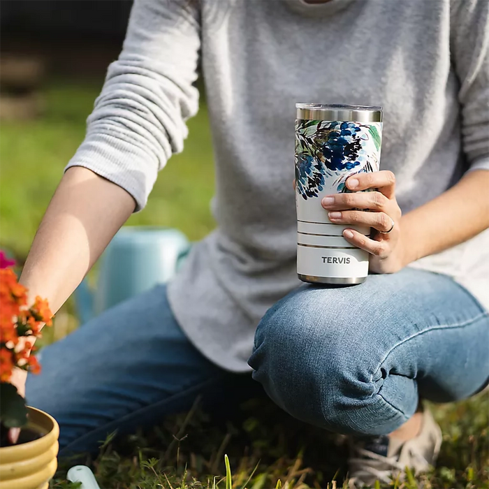 Person holding Tervis Kelly Ventura Protea tumbler with slider lid while gardening