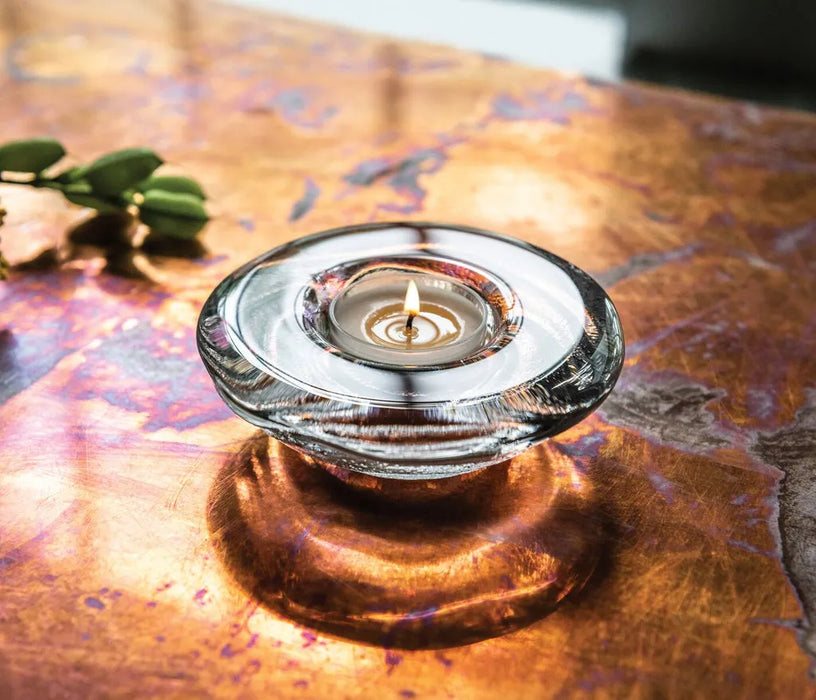 Tea Candle in a glass holder on a textured surface