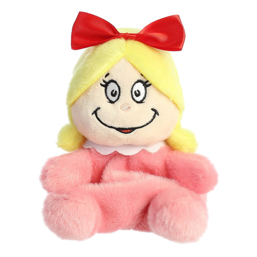 Plush toy with blonde hair, red bow, and pink outfit on a white background