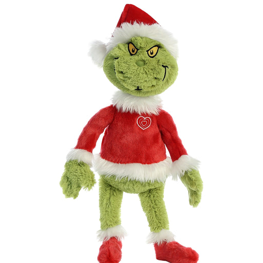 Plush toy resembling the Grinch with a red sweater and Santa hat on a white background
