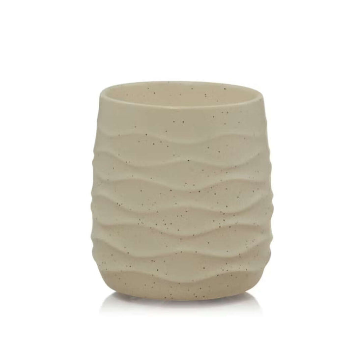 Beige ceramic candle warmer with textured surface on a white background