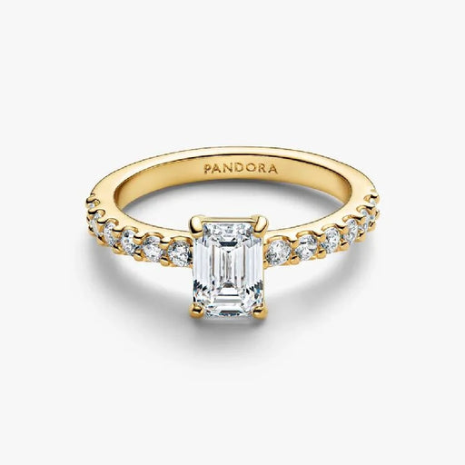 An emerald cut diamond engagement ring set in yellow gold, showcasing a classic and elegant design.
