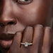 An exquisite yellow gold engagement ring with an emerald cut diamond, perfect for a proposal or special occasion.