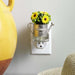 Decorative wall fragrance diffuser with  watering can and sunflower design on a neutral background