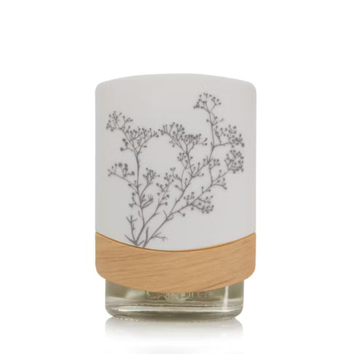 Plug in fragrance diffuser Night light with a  a floral design and featuring wooden base on a white background.