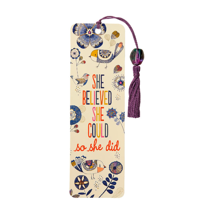A motivational bookmark with the phrase "She believed she could" in elegant typography on a colorful background.